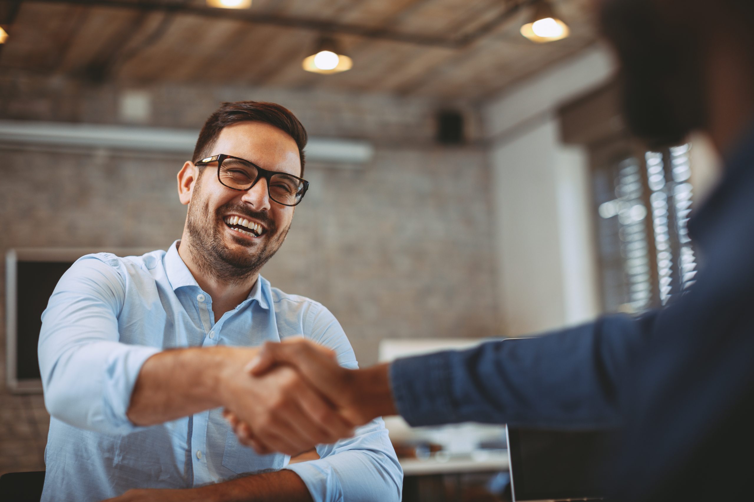 A Your Health Idaho vendor shaking hands across a table.
