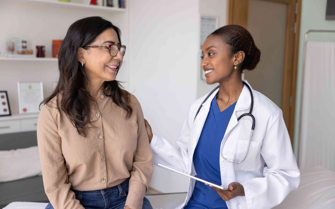 A woman without affordable health insurance is meeting with a woman doctor in an examination room.