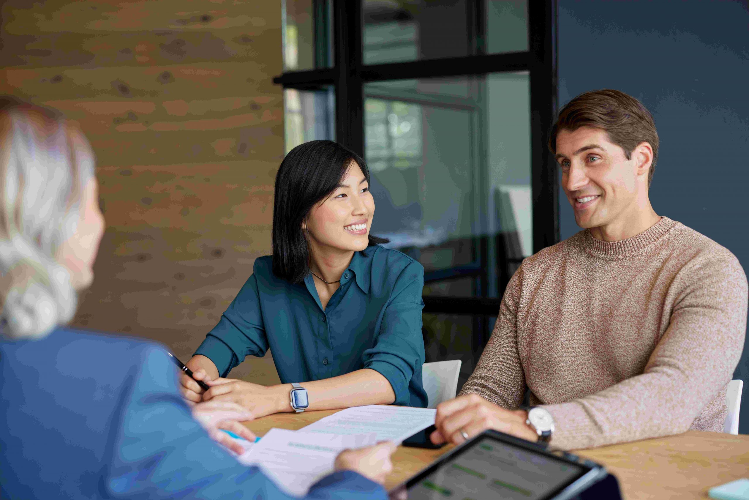 A couple in an office getting health insurance advice from certified agents and brokers.