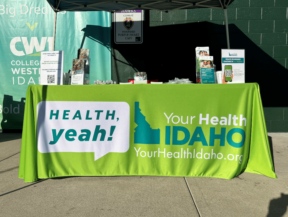 A Your Health Idaho booth set up with health insurance information for consumers at an outreach event.